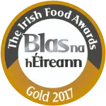 A circular gold and white badge reads "The Irish Food Awards" around the top edge, "Blas na hÉireann" in the center, and "Gold 2017" at the bottom.