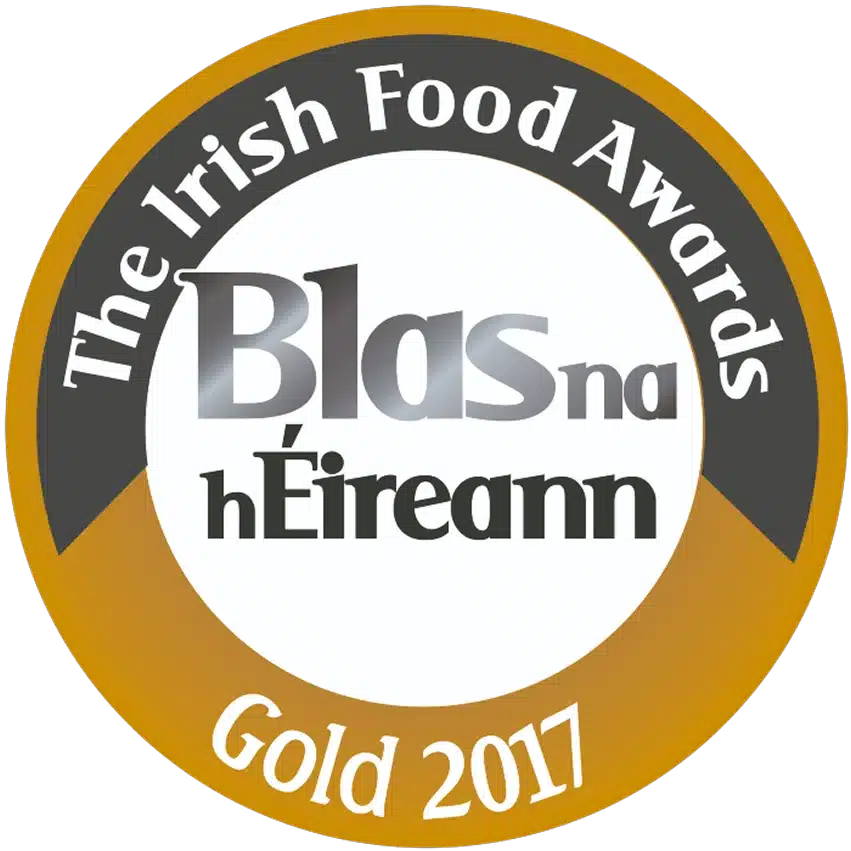 A circular gold and white badge with text: "The Irish Food Awards," "Blas na hÉireann," and "Gold 2017.