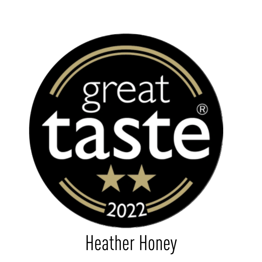 A black circular badge with golden accents, featuring the words "great taste" in white, two gold stars below, and "2022" at the bottom.