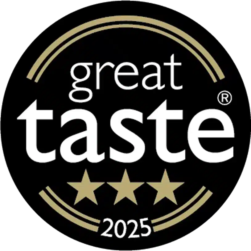 A black circular badge with gold accents, featuring the words "great taste" and three gold stars below, along with "2025" at the bottom.
