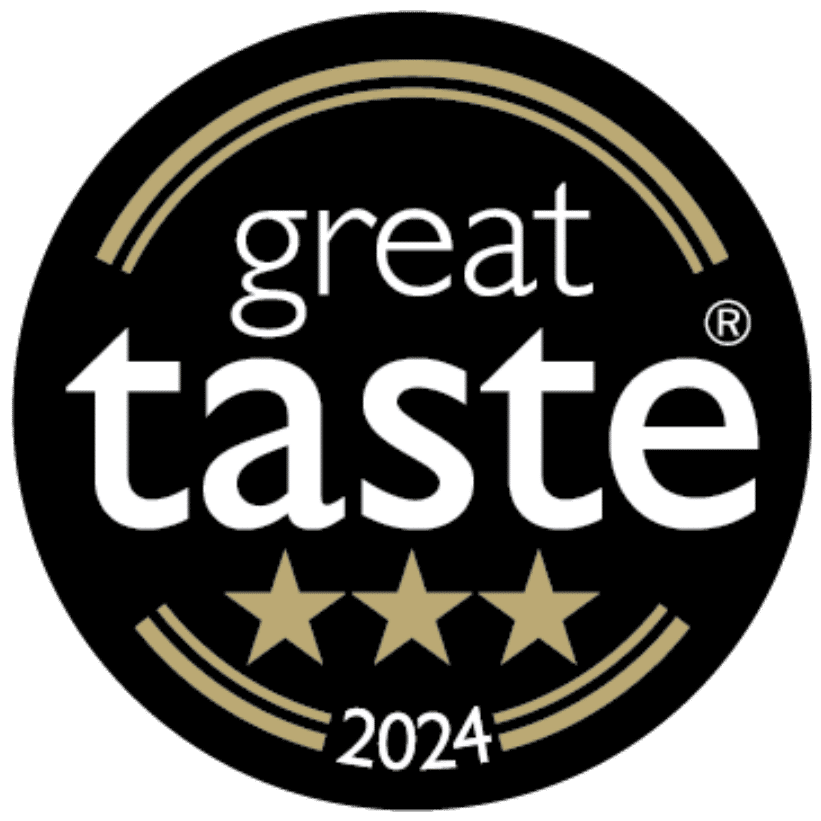 A round black badge with gold accents displaying the words "great taste" above three gold stars and "2024" at the bottom, signifying a 2024 Great Taste Award.
