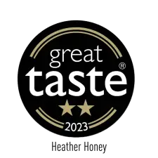 A black circular badge with gold accents reading "great taste" in white text, two gold stars below, and "2023" at the bottom, indicating a 2023 Great Taste Award.