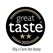 A circular black badge with gold accents reads “great taste” in bold white letters, features two gold stars below the word “taste,” and “2023” written underneath.