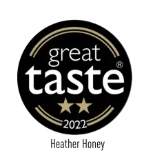 A black circular badge with golden accents, featuring the words "great taste" in white, two gold stars below, and "2022" at the bottom.