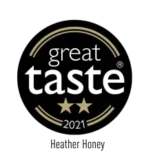 A black circular badge with gold lines framing the words "great taste" in white, two gold stars below, and "2021" at the bottom.