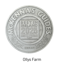 A round silver medallion with "McKennas Guides" on the rim and "Best in Ireland 2025" in the center, awarded to Ollys Farm, recommended by John & Sally McKenna’s Guides.
